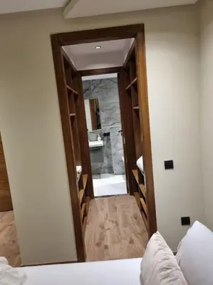 a bedroom with a door leading to a bathroom at charmant studio en plein cœur de maarif in Casablanca