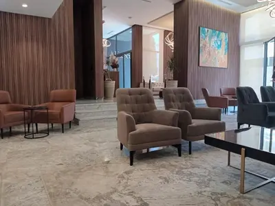 a waiting area with chairs and tables in a lobby at Executive Boutique Hotel Rabat in Rabat
