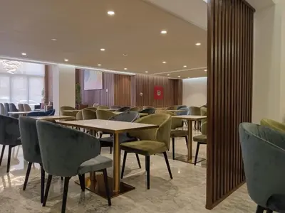 a waiting room with tables and chairs in a building at Executive Boutique Hotel Rabat in Rabat