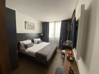 a hotel room with a bed and a desk at Executive Boutique Hotel Rabat in Rabat