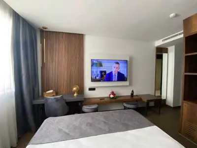 a hotel room with a bed and a tv on the wall at Executive Boutique Hotel Rabat in Rabat