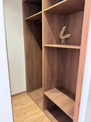 a wooden book shelf with a potted plant in it at APPARTEMENT LUXUEUX 29 neuf avec terrasse in Casablanca