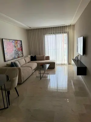 a living room with a couch and a table at APPARTEMENT LUXUEUX 29 neuf avec terrasse in Casablanca