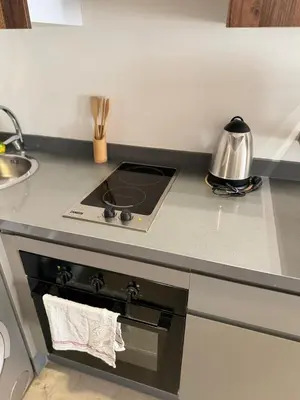 a kitchen counter with a stove and a sink at APPARTEMENT LUXUEUX 29 neuf avec terrasse in Casablanca