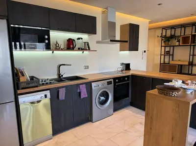 a kitchen with a sink and a washing machine at Classy presidential apartment in Casablanca
