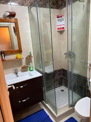 a bathroom with a shower and a sink and a toilet at Confort repos et belle vue mer in Bouznika