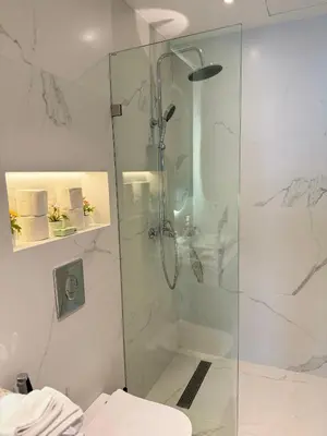 a bathroom with a glass shower with a toilet at Presidential living princess in Casablanca