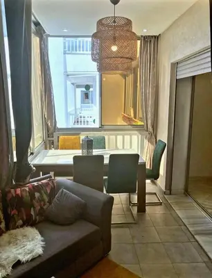 a living room with a couch and a table at La siesta beach resort two bedroom appartement in Mohammedia