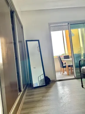 an empty room with a mirror and a room with a table at La siesta beach resort two bedroom appartement in Mohammedia