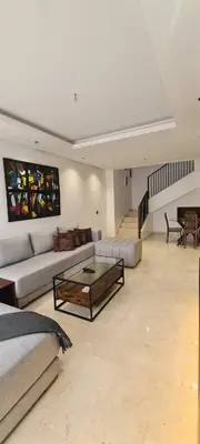 a living room with a couch and a coffee table at Duplex One Hill Ville Verte in Casablanca