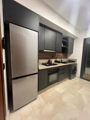 a kitchen with stainless steel appliances and black cabinets at Duplex One Hill Ville Verte in Casablanca