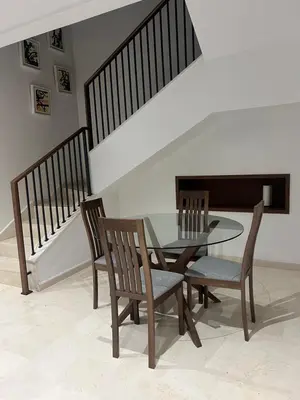 a dining room with a glass table and chairs at Duplex One Hill Ville Verte in Casablanca