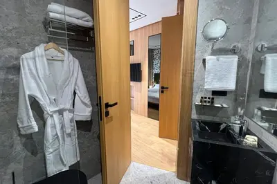 a bathroom with a white robe hanging on a door at Le studio in Casablanca