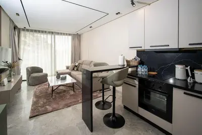 a kitchen with a table and a living room at Le studio in Casablanca
