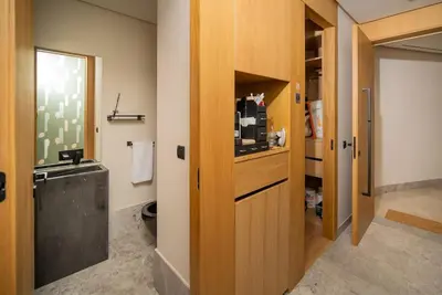 a bathroom with a sink and a wooden door at Le studio in Casablanca