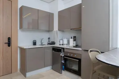 a kitchen with stainless steel appliances and a table at Magnifique Studio neuf in Casablanca