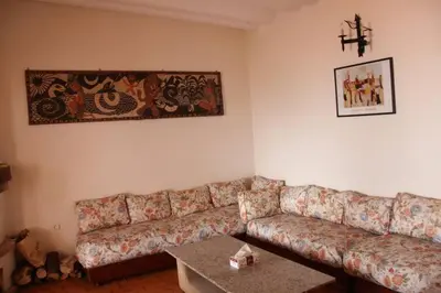 a living room with a couch and a table at Maison d'hôte sur la Plage de Bouznika in Bouznika