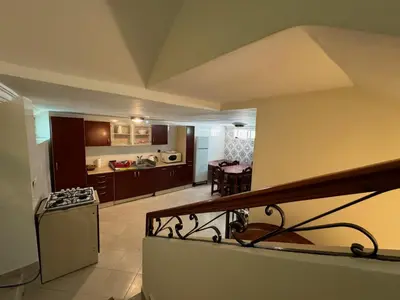 a view of a kitchen and a living room at Triplex à 5 min de la plage ! in Temara
