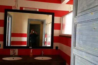 a man taking a picture of a mirror in a bathroom at Villa, piscine sans vis-à-vis in Casablanca