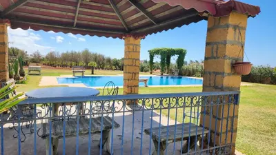 a patio with a table and chairs and a pool at Villa, piscine sans vis-à-vis in Casablanca