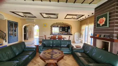 a living room with a couch and a table at Villa, piscine sans vis-à-vis in Casablanca
