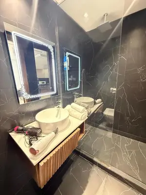 a bathroom with two sinks and a mirror at Cozy princesse living maarif in Casablanca