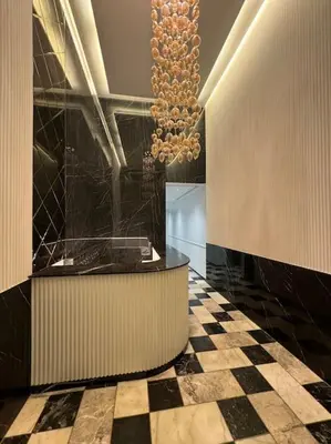 a lobby with a checkered floor and a chandelier at Cozy princesse living maarif in Casablanca