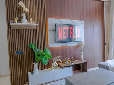 a living room with a television on a wall at Cozy princesse living maarif in Casablanca