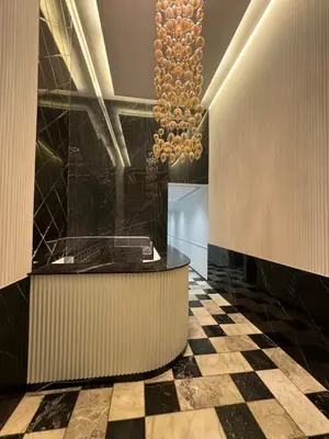 a lobby with a checkered floor and a chandelier at Cozy princesse living maarif in Casablanca
