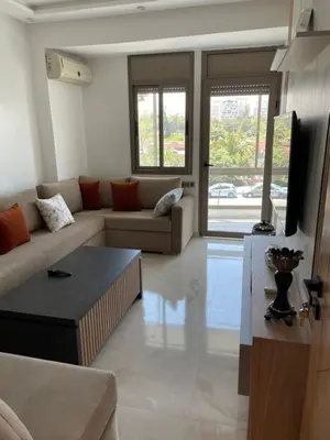 a living room with a couch and a table at La Belle Vue Cosy Apartment in Casablanca
