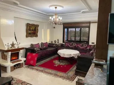 a living room with a couch and a fireplace at La Belle Vue Cosy Apartment in Casablanca