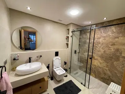 a bathroom with a shower and a toilet and a sink at La Belle Vue Cosy Apartment in Casablanca