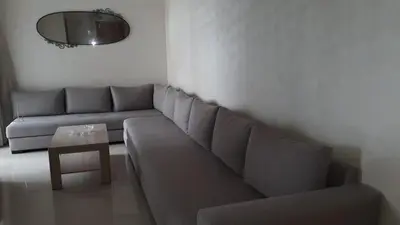 a living room with a couch and a table at Appartement Sidi Rahal in Berrechid