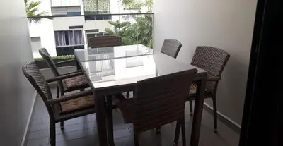 a dining room table with six chairs and a window at Appartement Sidi Rahal in Berrechid