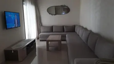 a living room with a couch and a table at Appartement Sidi Rahal in Berrechid