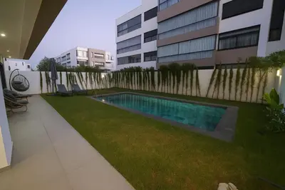 a swimming pool in a yard in a building at Sancy Luxury rez de jardin avec piscine privée in Casablanca