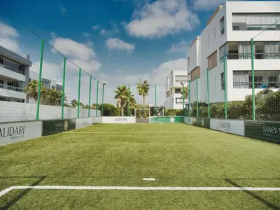an empty tennis court in front of a building at Sancy Luxury rez de jardin avec piscine privée in Casablanca