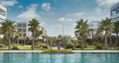 a swimming pool with palm trees in front of a building at Sancy Luxury rez de jardin avec piscine privée in Casablanca