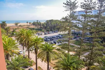 an aerial view of a parking lot with palm trees at Le Joyau du Parc in Mohammedia