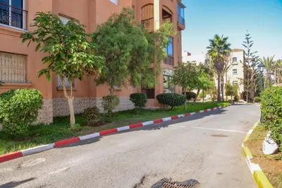 an empty street in front of a building at MOHAMMEDIA Rico Flores in Mohammedia