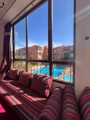 a couch in a room with a large window at MOHAMMEDIA Rico Flores in Mohammedia