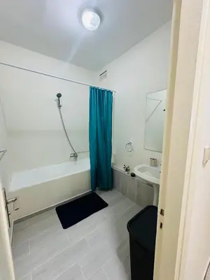 a bathroom with a bath tub and a sink at Appartement spacieux - BD Anfa in Casablanca