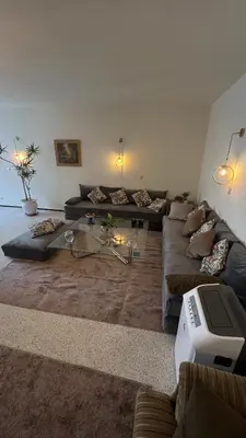 a living room with couches and a television in it at Appartement spacieux - BD Anfa in Casablanca