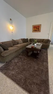 a living room with a couch and a coffee table at Appartement spacieux - BD Anfa in Casablanca