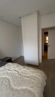 a white bedroom with a bed in a room at Jasmine's house in Casablanca