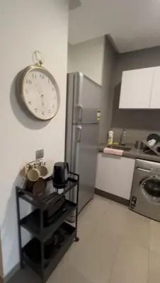 a kitchen with a refrigerator and a clock on the wall at Jasmine's house in Casablanca