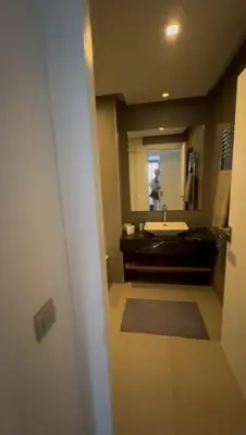 a bathroom with a sink and a person in the mirror at Jasmine's house in Casablanca