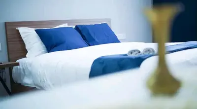 a bedroom with a bed with blue and white pillows at Bleu Studio in Rabat