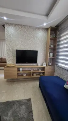 a living room with a flat screen tv on a wall at Cité Marine in Mansouria