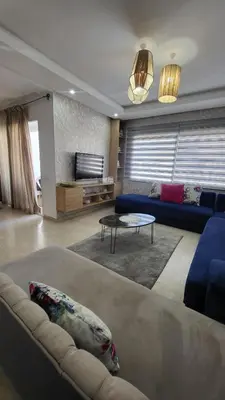 a living room with a couch and a table at Cité Marine in Mansouria